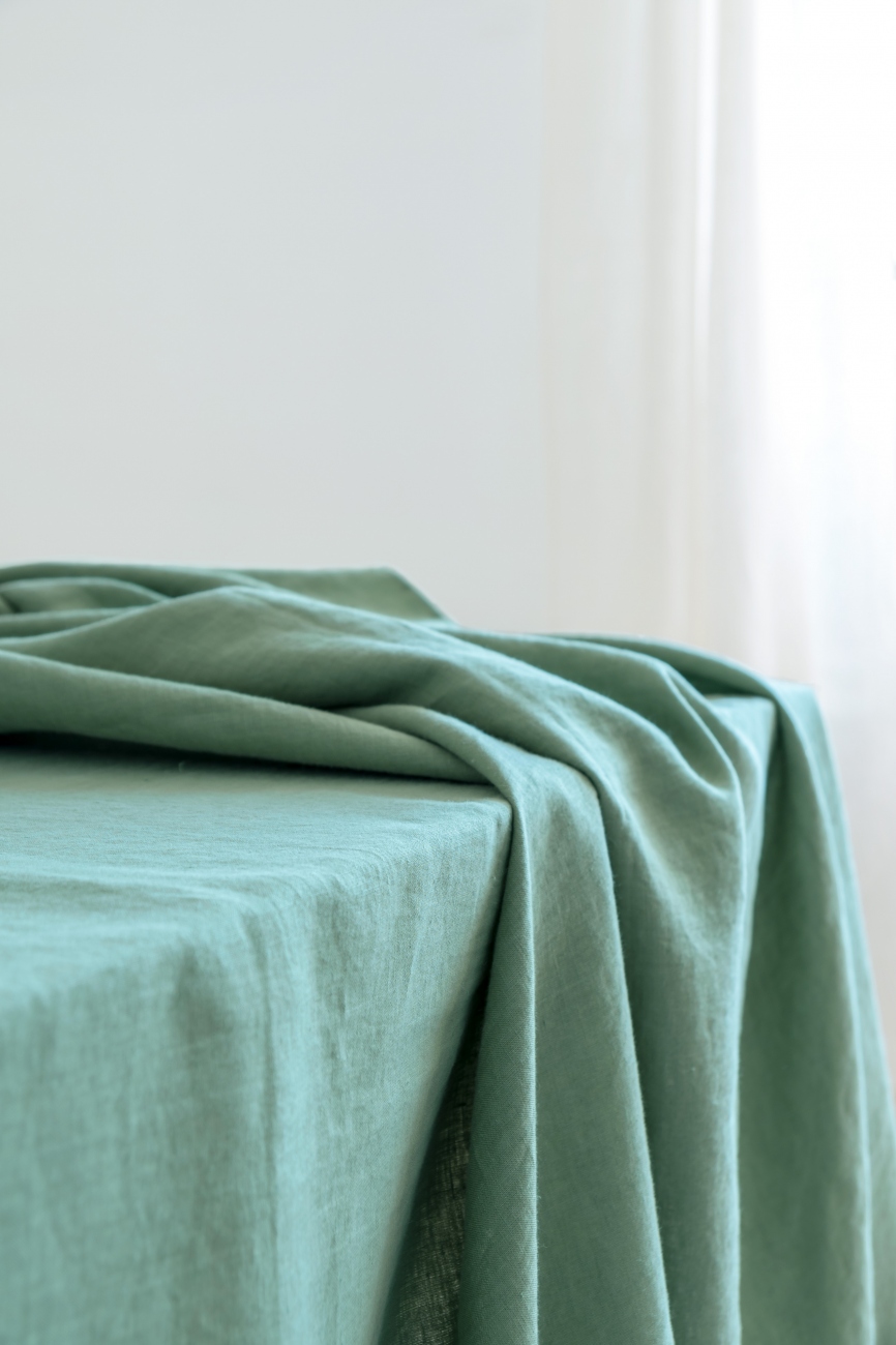 Washed linen tablecloth in basil green