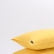 Yellow washed linen pillowcase with an envelope closure